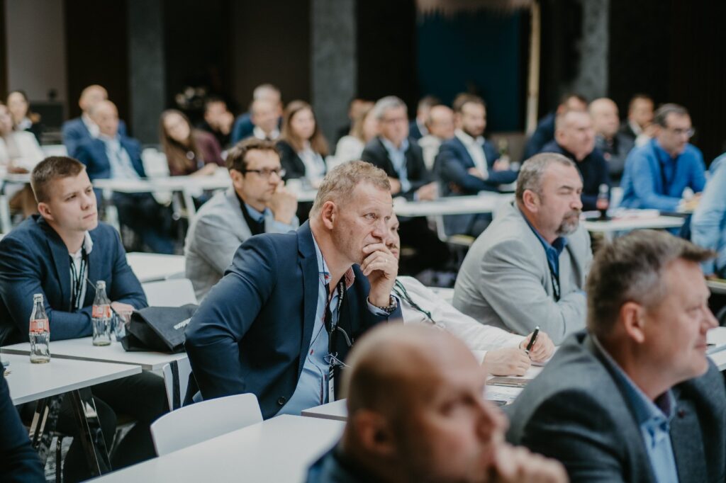 Guests listening to a keynote speech at a business event in Prague